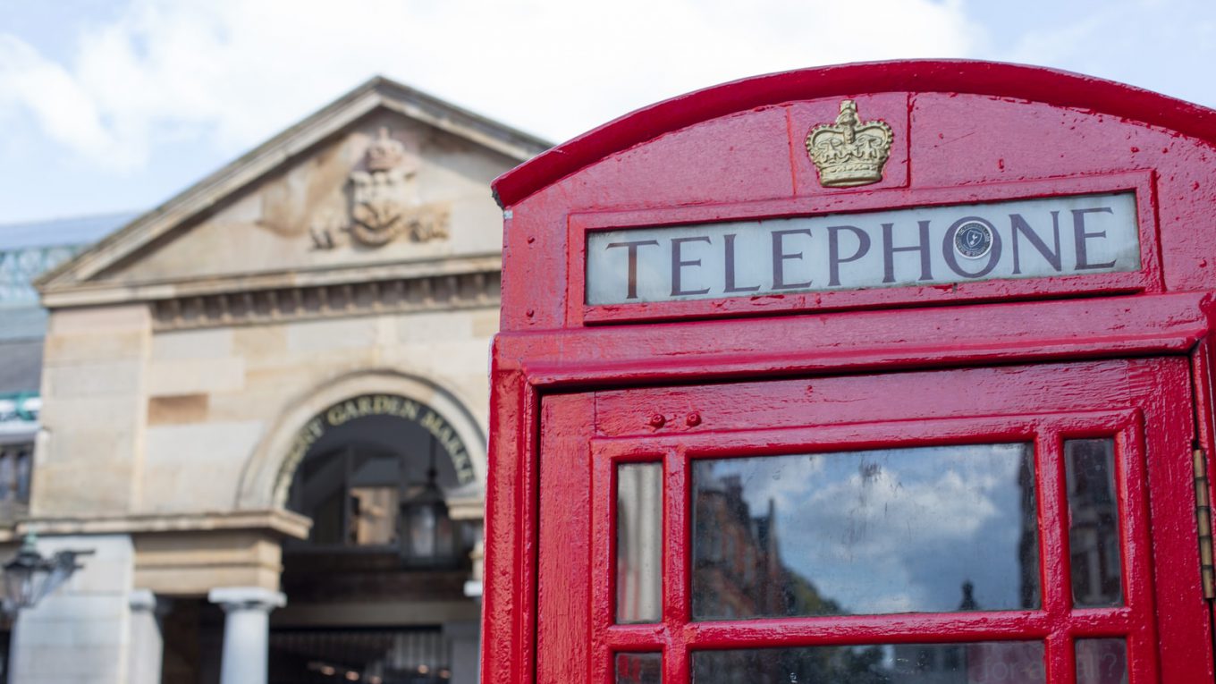 red telephone booth near building during daytime